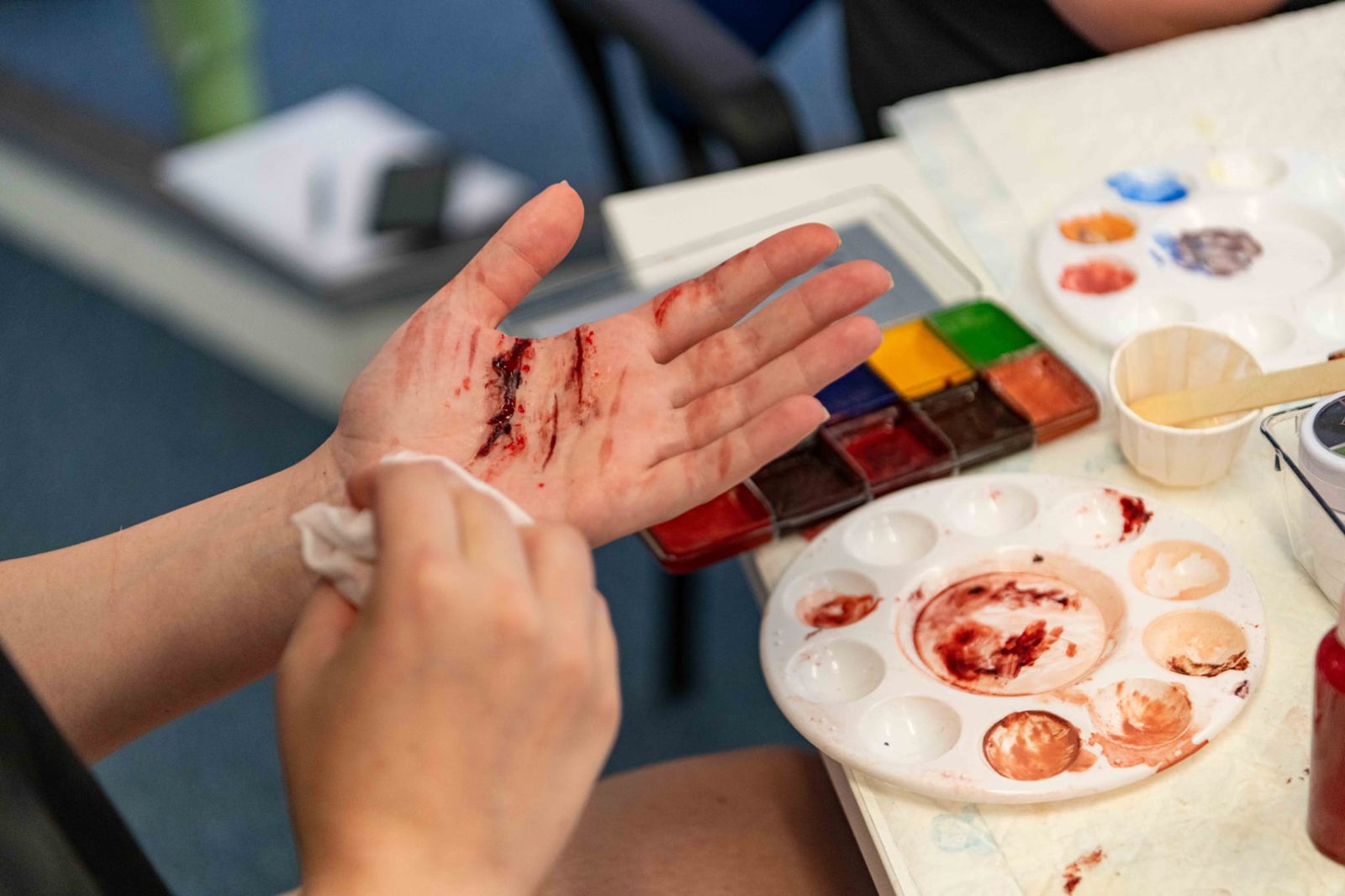 Grazing moulage to the hand being blotted, colour palette alongside